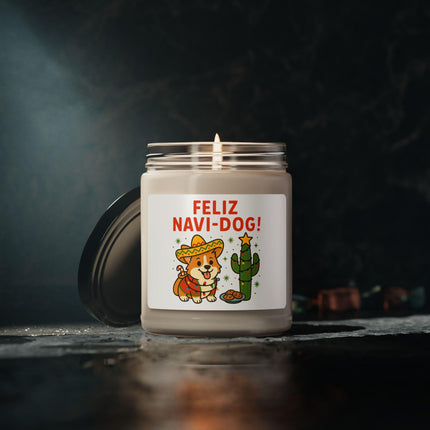 "Lit 'Feliz Navi-Dog!' candle with a festive Corgi wearing a sombrero and a decorated cactus design on the label, displayed against a dark moody background with soft lighting. The candle’s warm glow reflects on the textured surface, creating a cozy, elegant holiday atmosphere."