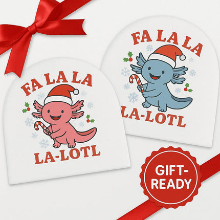 "Two white baby beanies featuring Christmas axolotl designs. One beanie shows a pink axolotl wearing a Santa hat and holding a candy cane; the other features a blue axolotl in the same style. Both display the phrase ‘FA LA LA LA-LOTL’ in red text. A red ribbon decorates the top corner and a red badge labeled ‘GIFT-READY’ appears on the right side."