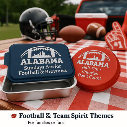 "Two personalized Alabama football-themed bakeware pieces — a navy blue rectangular cake pan engraved with 'Sundays Are for Football & Brownies' and a red round pie tin engraved with 'Half Time Calories Don’t Count' — displayed on a red and white checkered picnic tablecloth. A football helmet, foam finger, footballs, and a cooler sit in the background, emphasizing the tailgate setting. Text at the bottom reads 'Football & Team Spirit Themes – For families or fans.'&q