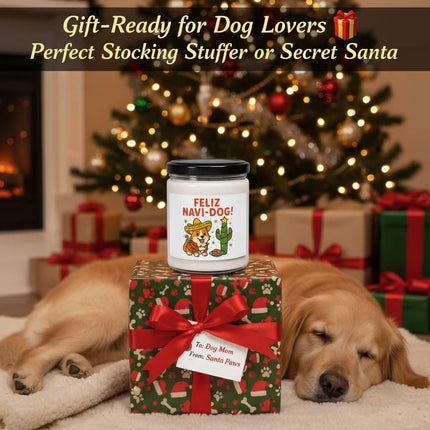 "Festive holiday scene featuring a 'Feliz Navi-Dog!' candle placed on a wrapped gift box with a red ribbon and tag reading 'To: Dog Mom, From: Santa Paws.' A golden retriever sleeps peacefully beside the present in front of a decorated Christmas tree with twinkling lights and ornaments. Text above reads 'Gift-Ready for Dog Lovers 🎁 Perfect Stocking Stuffer or Secret Santa.'"