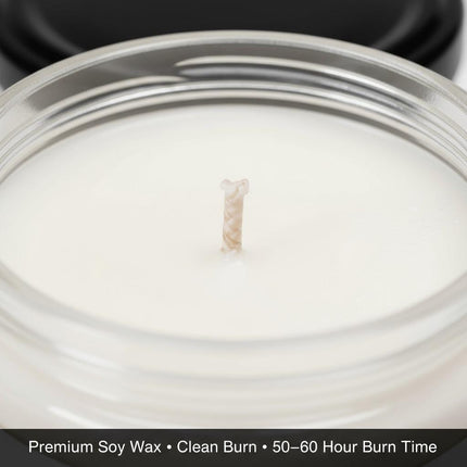"Close-up view of an unused white soy wax candle with a centered cotton wick inside a clear glass jar. The label at the bottom reads 'Premium Soy Wax • Clean Burn • 50–60 Hour Burn Time,' emphasizing candle quality and long-lasting performance."