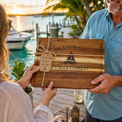 Islamorada Florida Keys personalized cutting board being given as a gift on a dock at sunset with boats water and tropical marina background