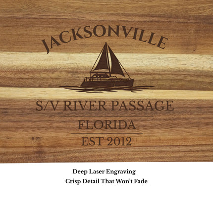 Close up of Jacksonville Florida sailboat cutting board engraving showing detailed sailboat design and clean acacia wood grain