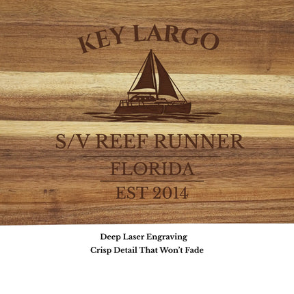 Close up of Key Largo Florida Keys sailboat cutting board engraving showing detailed sailboat design and clean acacia wood grain
