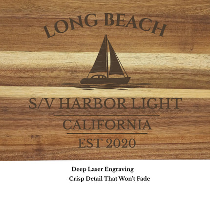 Close up of Long Beach California sailboat cutting board engraving showing detailed laser etched sailboat design and acacia wood grain