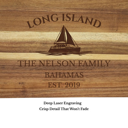 Close up of Long Island Bahamas sailboat cutting board engraving showing detailed sailboat design and acacia wood grain