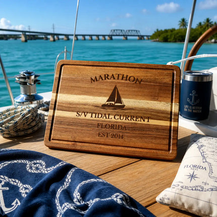 Marathon Florida sailboat cutting board on a boat cockpit table with turquoise water and Seven Mile Bridge background in the Florida Keys