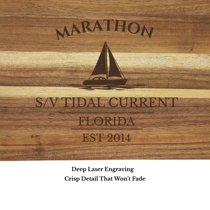 Close up of Marathon Florida sailboat cutting board engraving showing detailed sailboat design and acacia wood grain