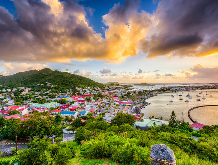 Panoramic view of Marigot Harbor in Saint Martin featuring the colorful French Caribbean waterfront, protected harbor basin, anchored sailboats, and surrounding hills overlooking one of the island's premier cruising destinations.
