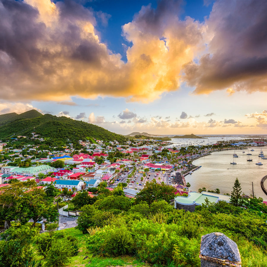 Panoramic view of Marigot Harbor in Saint Martin featuring the colorful French Caribbean waterfront, protected harbor basin, anchored sailboats, and surrounding hills overlooking one of the island's premier cruising destinations.