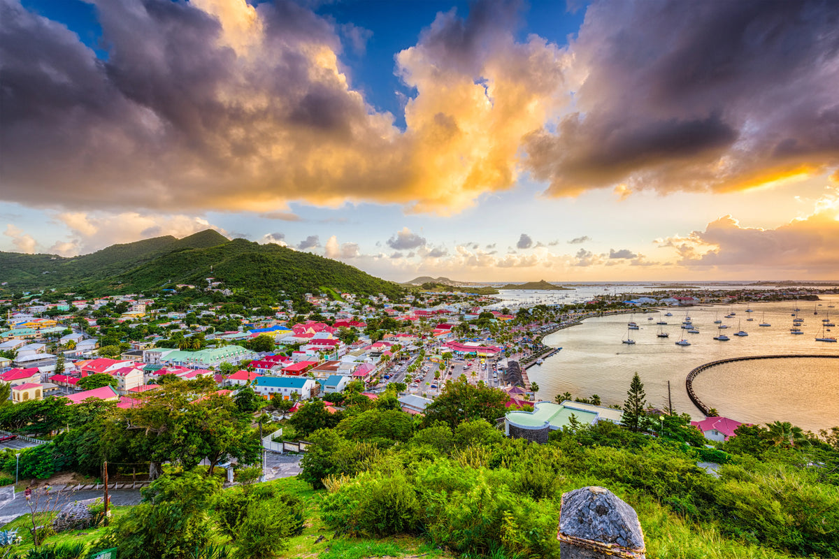 Panoramic view of Marigot Harbor in Saint Martin featuring the colorful French Caribbean waterfront, protected harbor basin, anchored sailboats, and surrounding hills overlooking one of the island's premier cruising destinations.