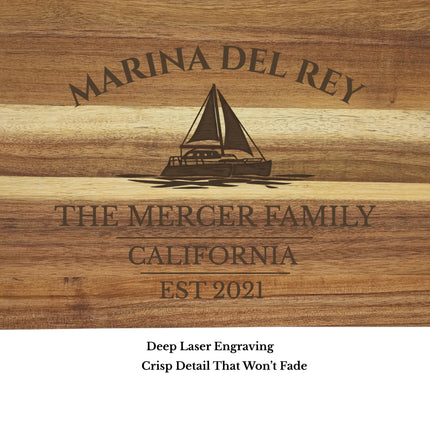 Close up of Marina del Rey cutting board engraving showing detailed sailboat design and laser etched wood grain texture