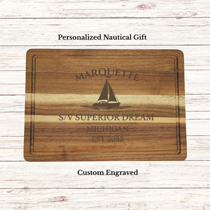Personalized Marquette Michigan sailboat cutting board engraved with family name and boat name on premium acacia wood