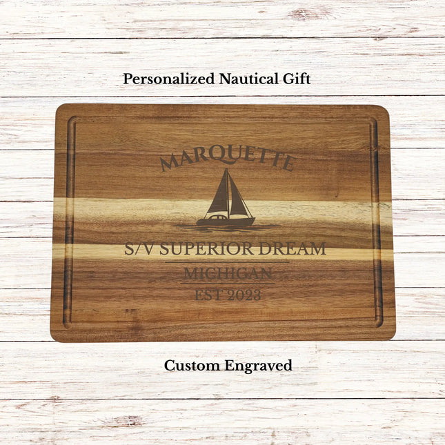 Personalized Marquette Michigan sailboat cutting board engraved with family name and boat name on premium acacia wood