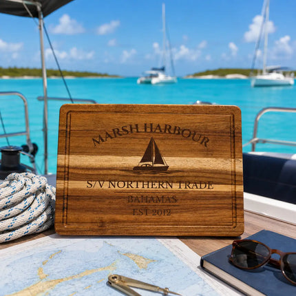 Marsh Harbour Bahamas sailboat cutting board on a catamaran cockpit table overlooking calm turquoise Abacos anchorage water and cruising sailboats