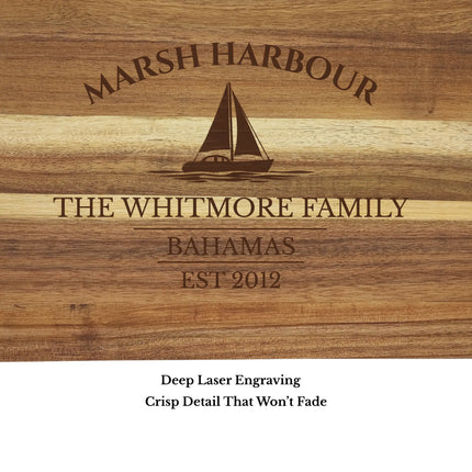 Close up of Marsh Harbour Bahamas sailboat cutting board engraving showing detailed sailboat design and acacia wood grain