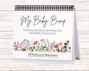 Coloring book titled 'My Baby Bump' on a wooden surface