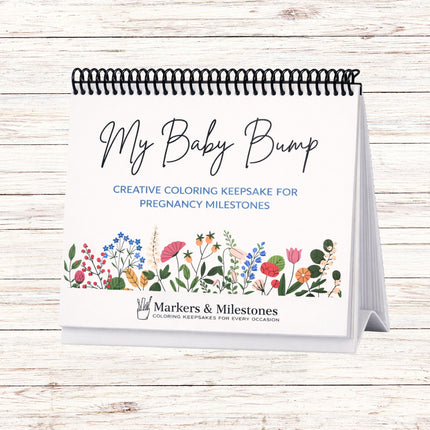 Coloring book titled 'My Baby Bump' on a wooden surface