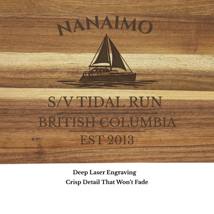 Close up of Nanaimo British Columbia sailboat cutting board engraving showing detailed sailboat design and clean acacia wood grain