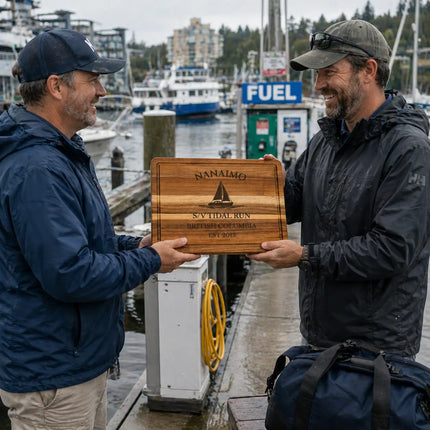 Nanaimo British Columbia personalized cutting board being handed between sailors on a marina dock with boats and fuel dock in the background