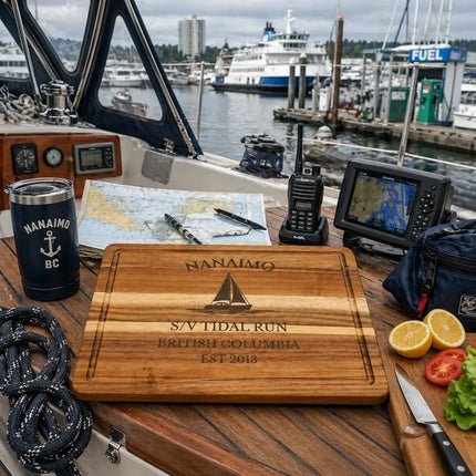 Nanaimo British Columbia sailboat cutting board on a cockpit table with navigation chart radio rope and food prep during an active marina stop