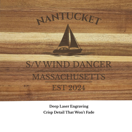 close up engraving detail Nantucket Massachusetts sailboat cutting board showing laser engraved sailboat and harbor name