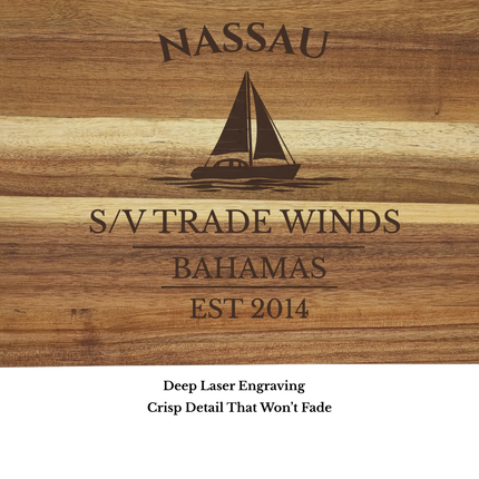 Close up of Nassau Bahamas sailboat cutting board engraving showing detailed sailboat design and acacia wood grain