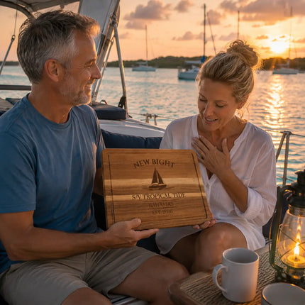 New Bight Bahamas personalized cutting board being shared between a longtime cruising couple during a peaceful sunset anchorage on Cat Island