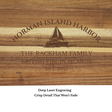 Close up of Norman Island Harbor British Virgin Islands sailboat cutting board engraving showing detailed sailboat design and clean acacia wood grain