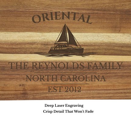Close up of Oriental North Carolina sailboat engraving on acacia wood cutting board showing detailed laser engraving