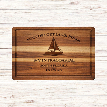 Personalized Fort Lauderdale sailboat cutting board engraved with a monohull sailboat, boat name S/V Intracoastal, South Florida home port, and established year on solid acacia wood.