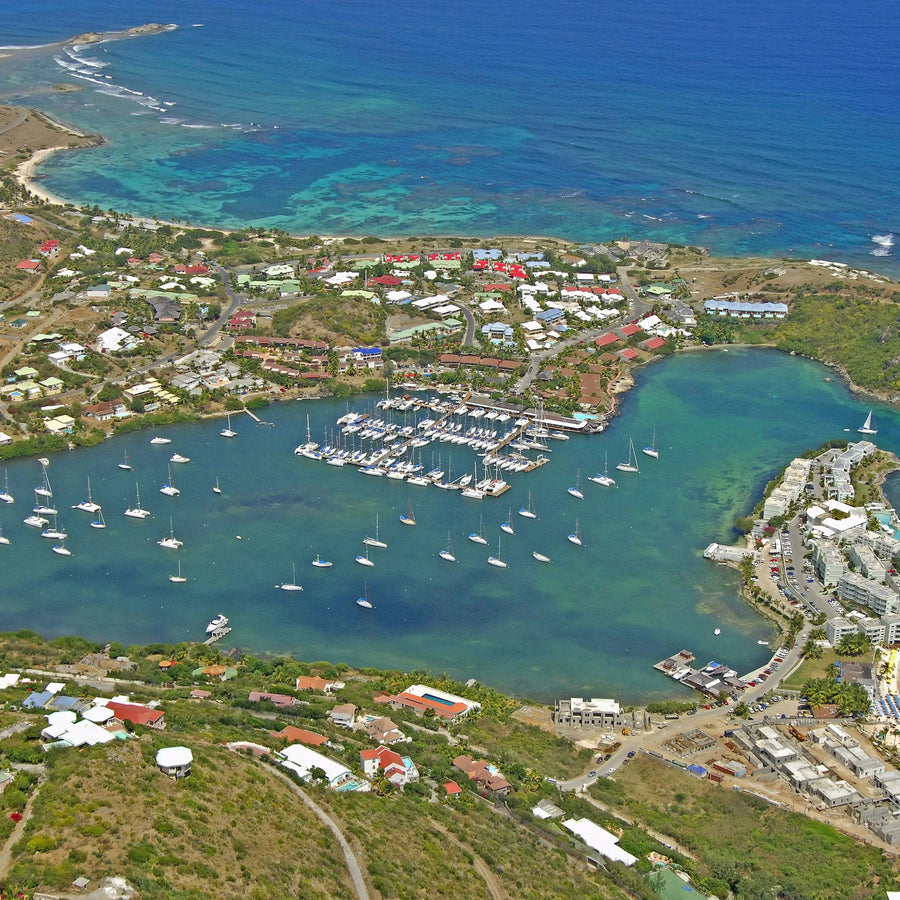 Protected waters of Oyster Pond Harbor in Saint Martin featuring anchored sailboats, waterfront homes, and a sheltered Caribbean harbor setting