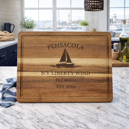 pensacola florida sailboat cutting board displayed in coastal kitchen with gulf coast marina view
