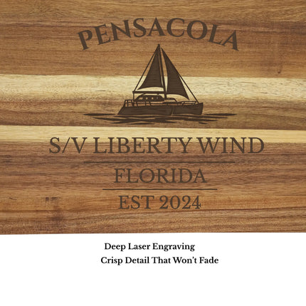 close up of pensacola sailboat cutting board engraving detail custom boat name on acacia wood