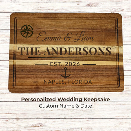 Personalized nautical wedding cutting board engraved with couple name and date in a clean studio setting