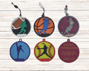 Set of sports-themed keychains on a wooden surface