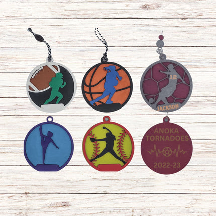 Set of sports-themed keychains on a wooden surface