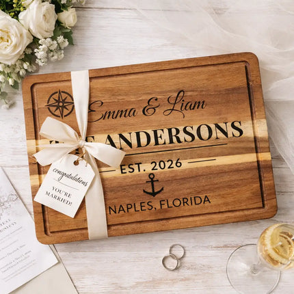 Personalized cutting board wrapped as a wedding gift with ribbon and tag for a couple