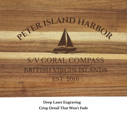 Close up of Peter Island Harbor British Virgin Islands sailboat cutting board engraving showing detailed sailboat design and clean acacia wood grain
