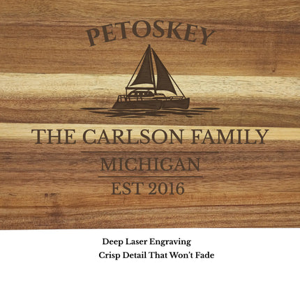close up of Petoskey Michigan sailboat cutting board engraving custom boat name and family name acacia wood detail