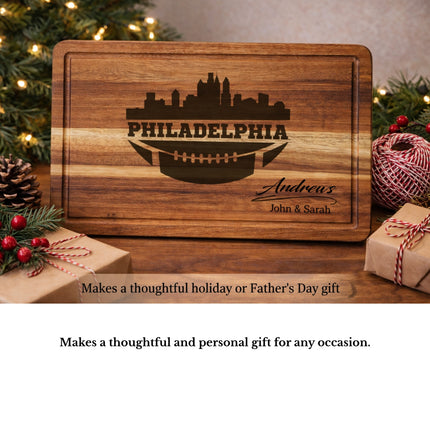 Personalized Philadelphia football cutting board displayed as a gift idea surrounded by wrapped presents and holiday decor
