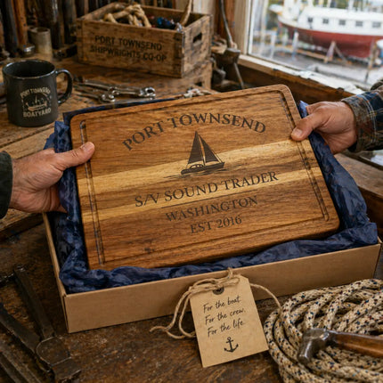 Port Townsend Washington personalized cutting board being given as a nautical gift in a boat workshop setting with tools and rope
