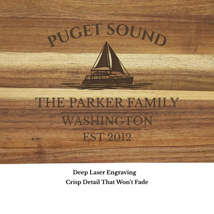 Close up of Puget Sound Washington sailboat cutting board engraving showing detailed sailboat design and clean acacia wood grain