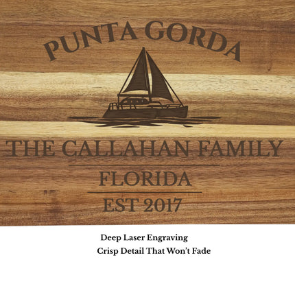 close up of punta gorda sailboat cutting board engraving detail custom family name on acacia wood