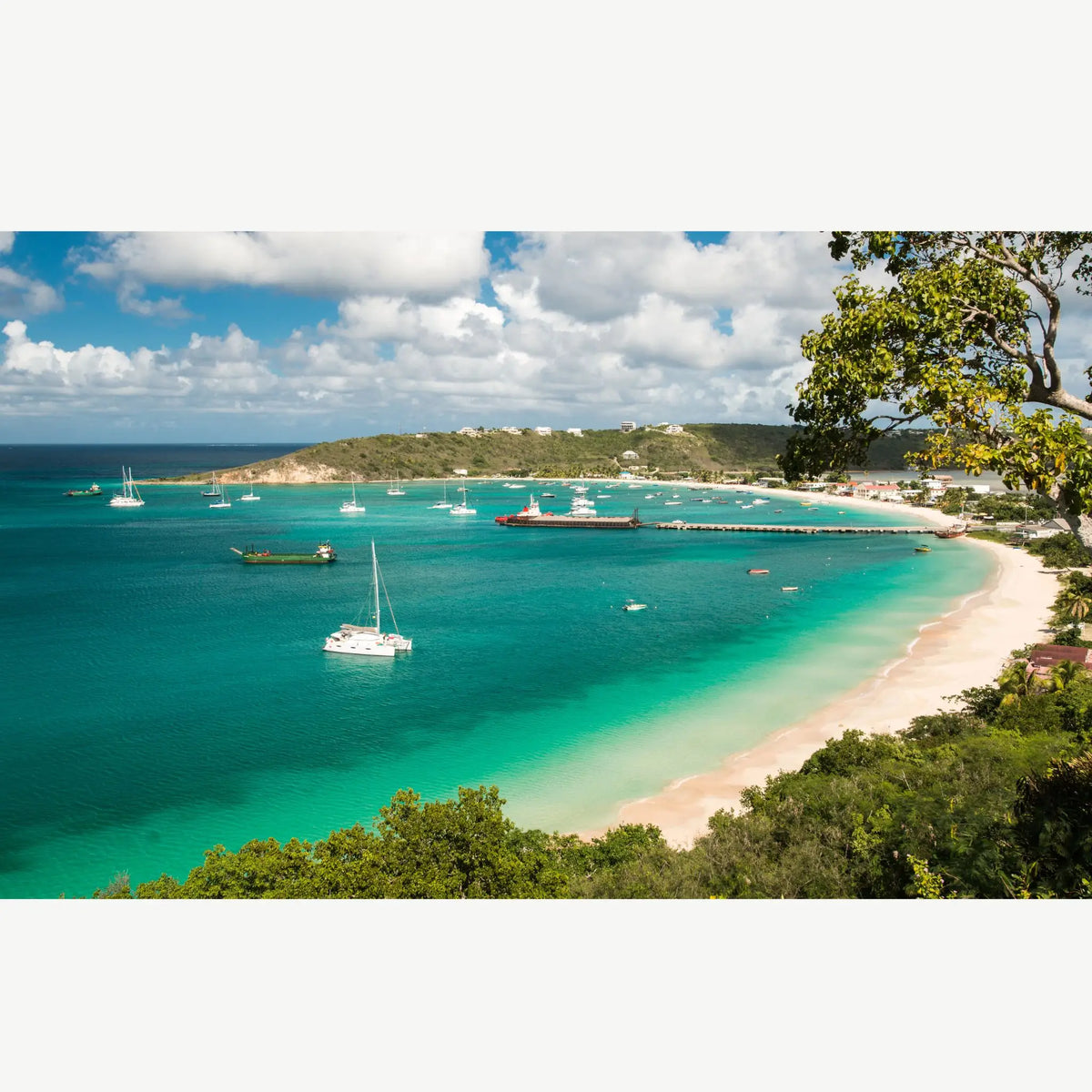 Anchored sailboats and turquoise waters in Road Bay Harbor, Anguilla, a popular Caribbean cruising destination and gateway to the Leeward Islands