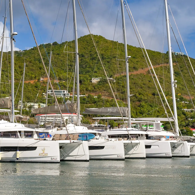 Luxury charter catamarans moored at a marina in Road Town, Tortola, British Virgin Islands, ready for sailing adventures throughout the BVI.