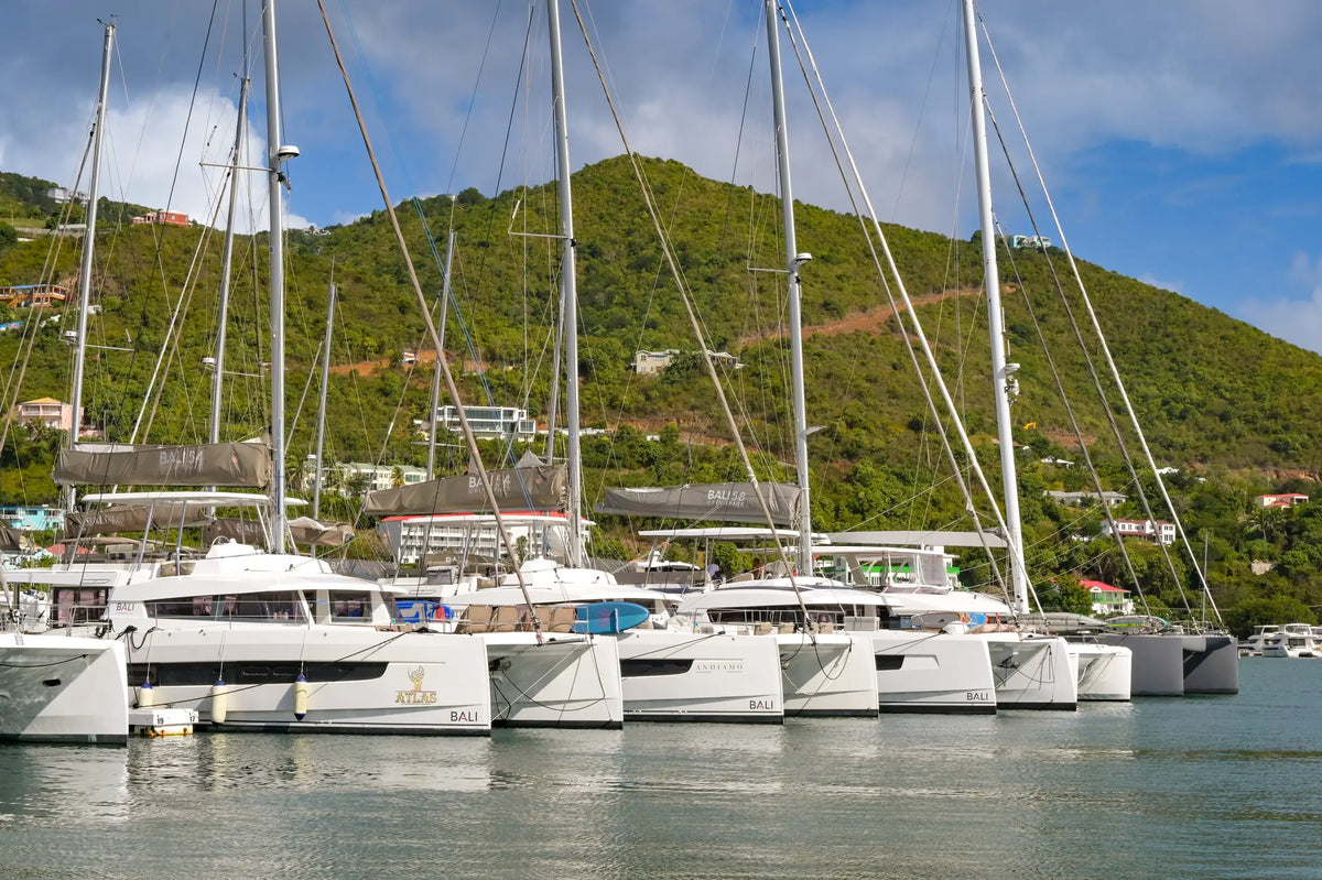 Luxury charter catamarans moored at a marina in Road Town, Tortola, British Virgin Islands, ready for sailing adventures throughout the BVI.