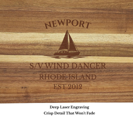 Close up of deep laser engraving on personalized sailboat cutting board showing crisp engraving detail in acacia wood