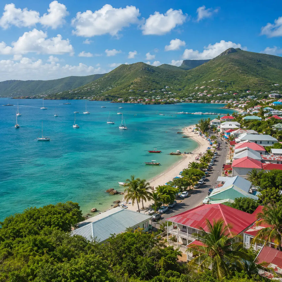 Aerial view of a protected harbor and anchorage along the northern coast of Saint Martin featuring sailboats, turquoise water, and nearby cruising destinations
