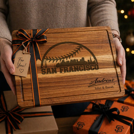 Personalized San Francisco baseball cutting board presented as a gift with orange and black ribbon and wrapped boxes